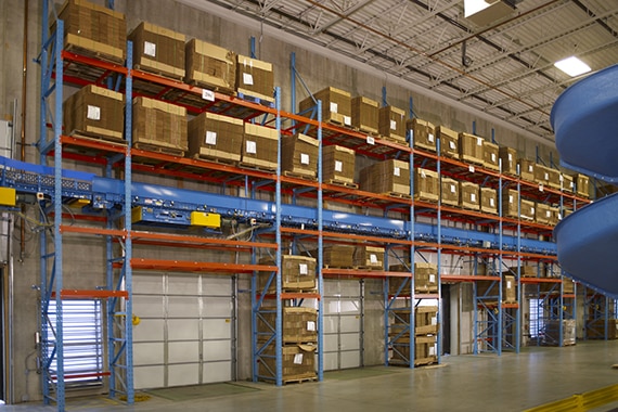 dock area with over dock racks loaded with empty pallets