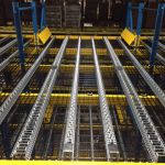 pallet flow for pick module with safety grating under lanes